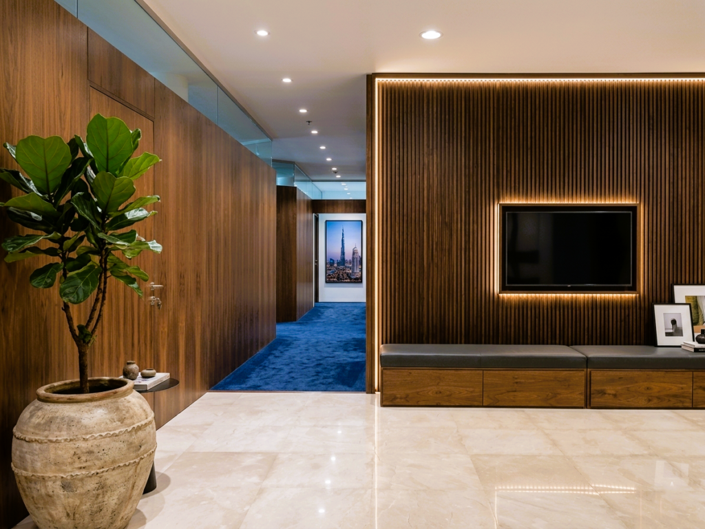 Wood wall cladding UAE in modern Dubai luxury villa interior with fluted panels and warm lighting