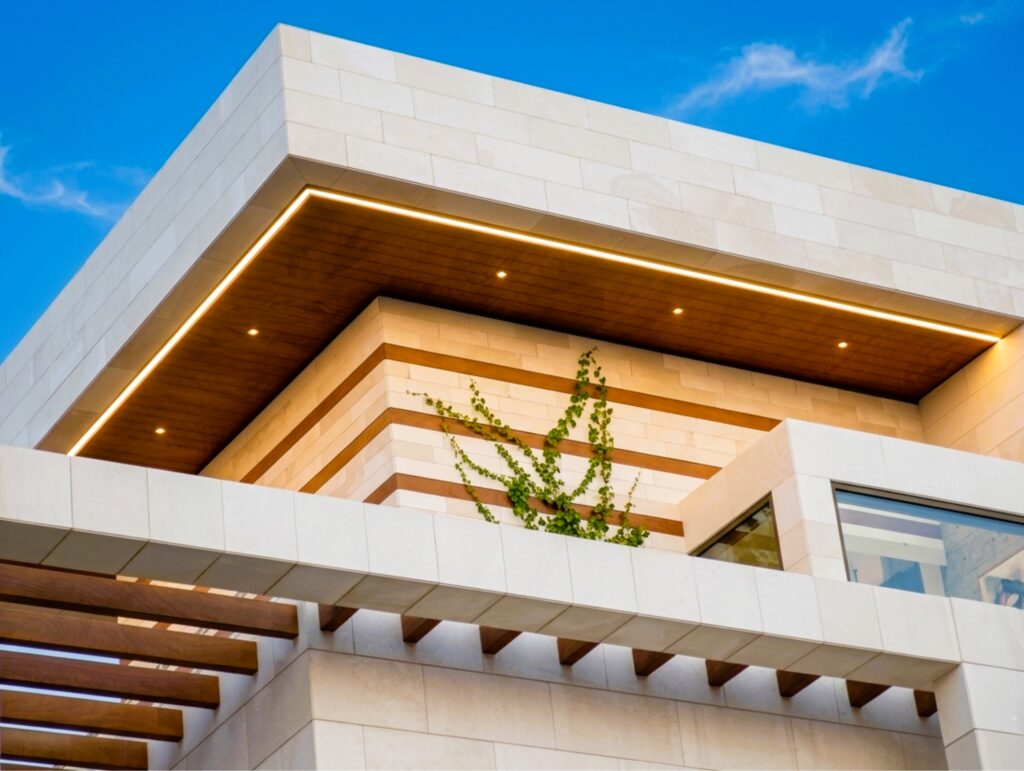 Exterior soffit cladding under a modern entrance canopy in the UAE.